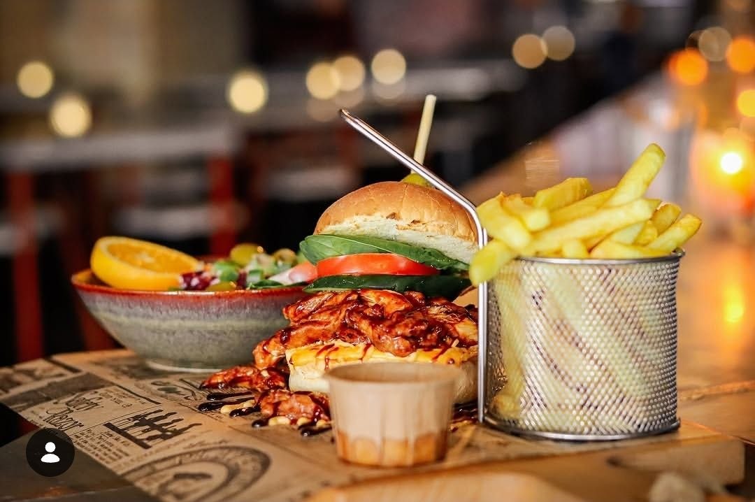 Drinkers Pub burger served with fries and salad